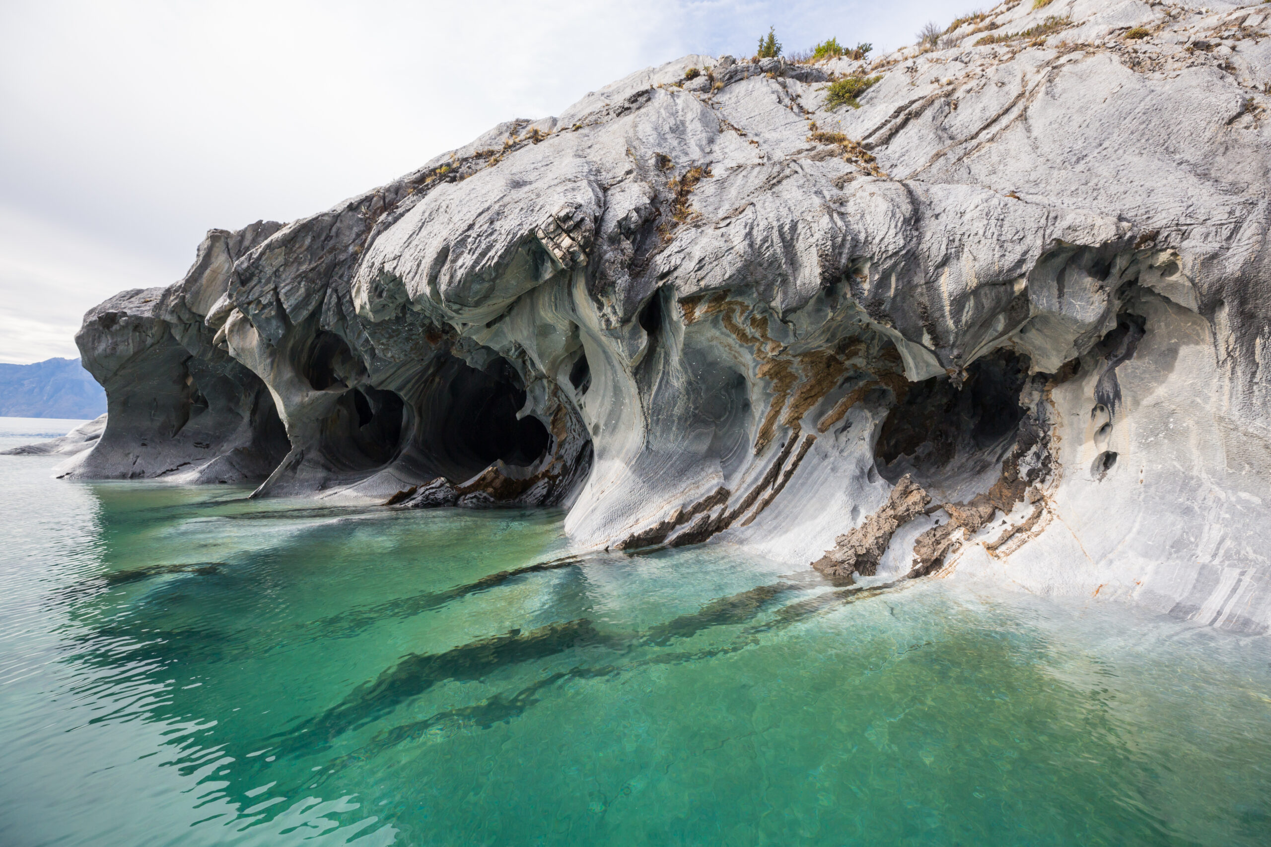 Natural rock arches and green light inside Devetashka Cave, a geological masterpiece near the Ionian coastline