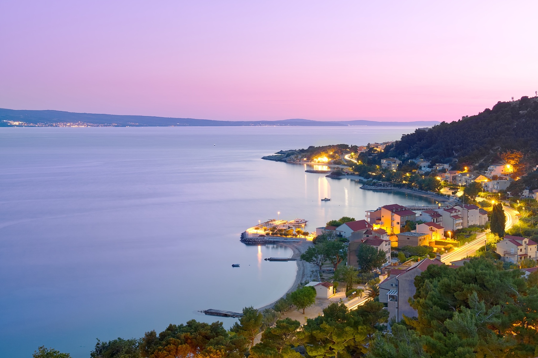 panoramic view of makarska riviera at sunset with lights and coastline croatia